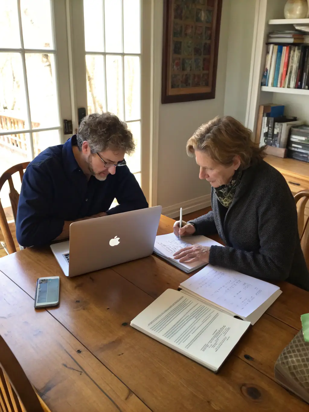 A photograph of a volunteer public writer assisting a community member with their writing project at Espace Culturel Eyraguais, emphasizing the personalized support offered.